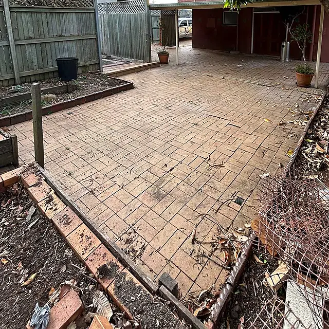 Brick paving covered in leaves and grime before cleaning