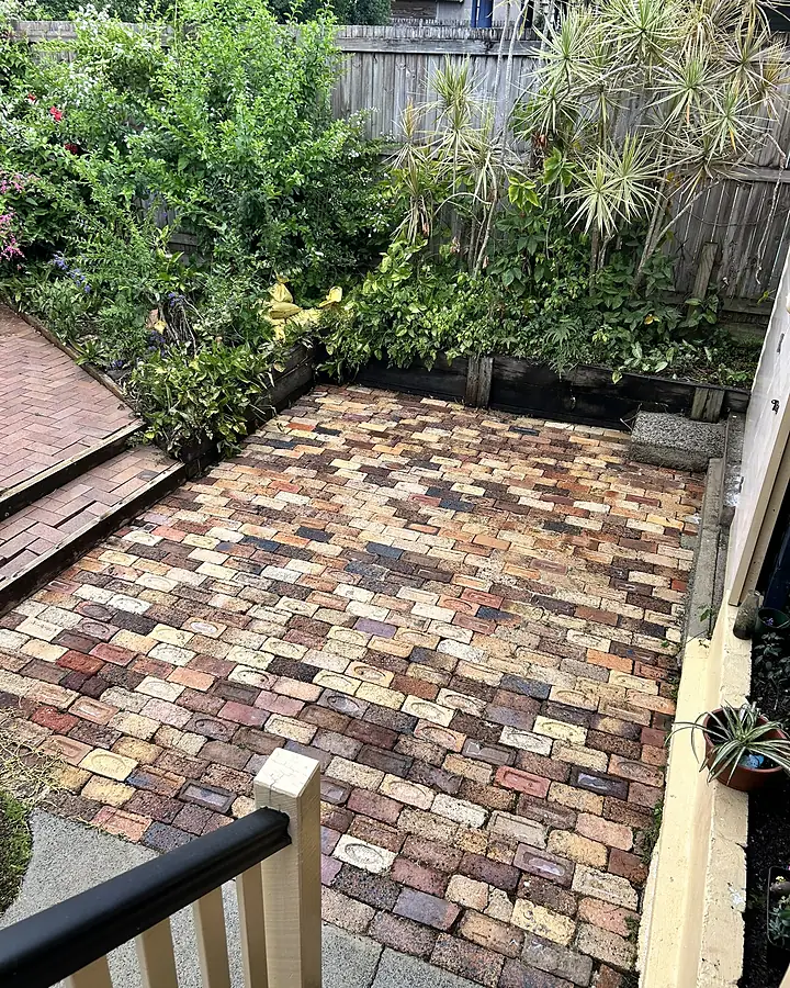 The same pavers after cleaning, with most but not all weed growth removed