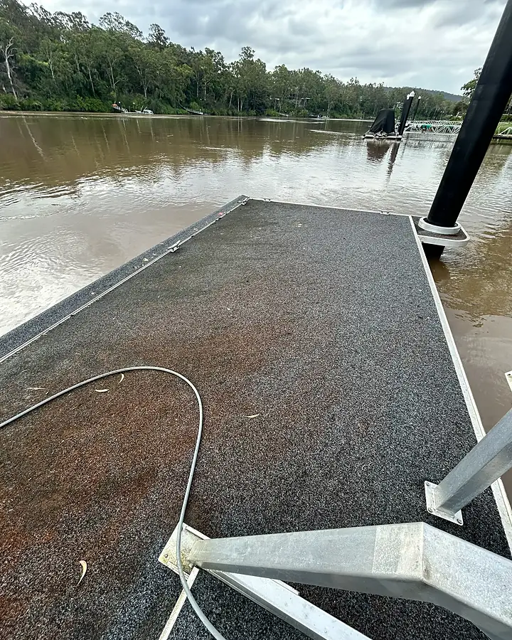 Marine carpet on a river pontoon stained rust brown before cleaning