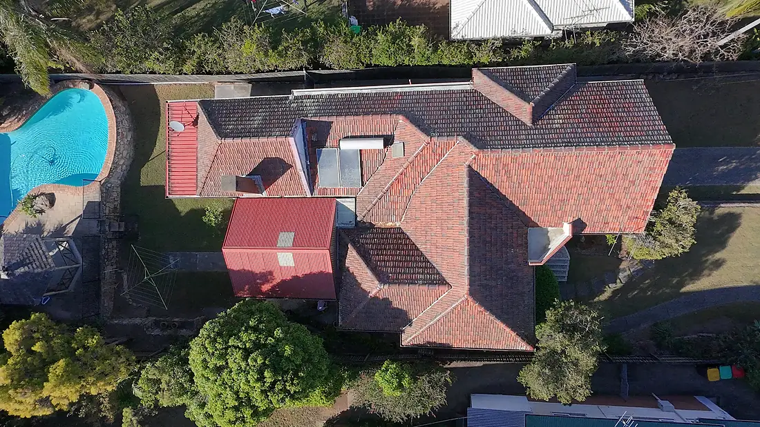 Drone view of a heavily soiled tile roof in Moorooka before cleaning