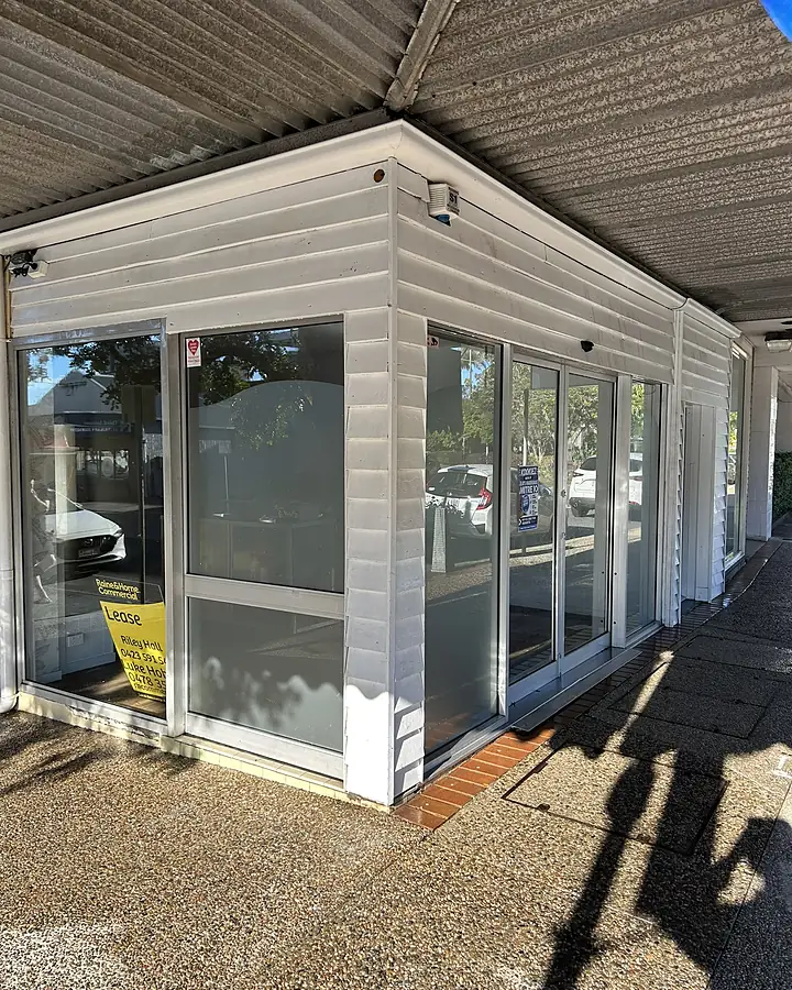 The same shopfront after cleaning, the cladding bright white