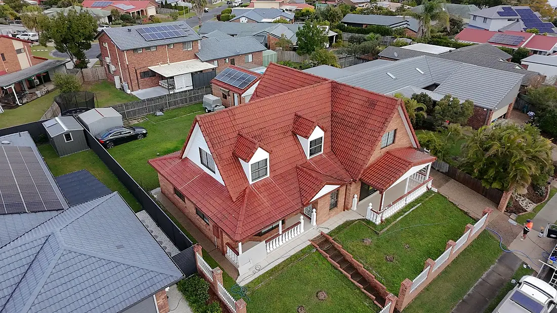 Drone view of a steep terracotta roof with dormers after cleaning