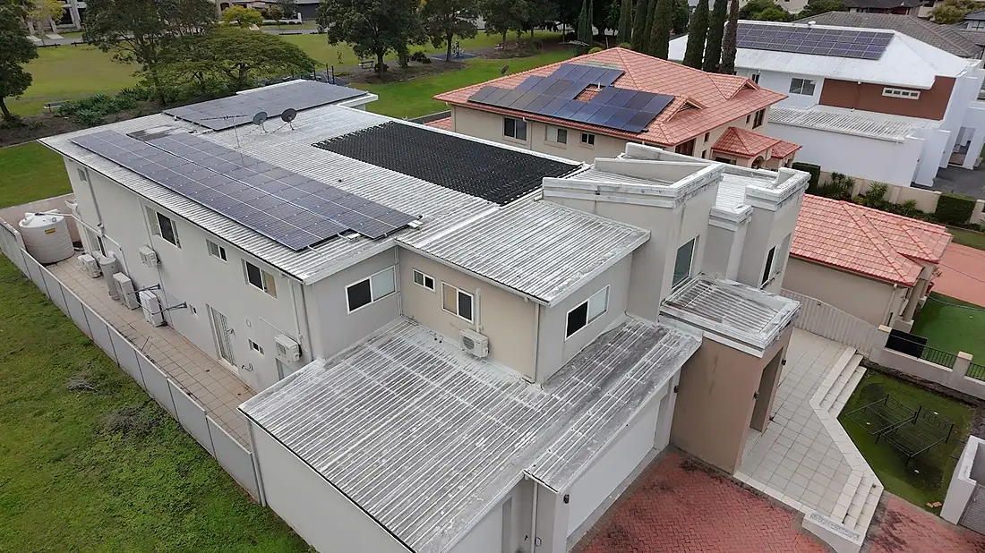 Drone view of a large two-storey rendered Sunnybank house before its exterior wash
