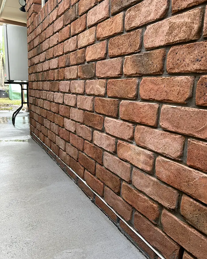 The same brickwork clean and red again, the path pale grey