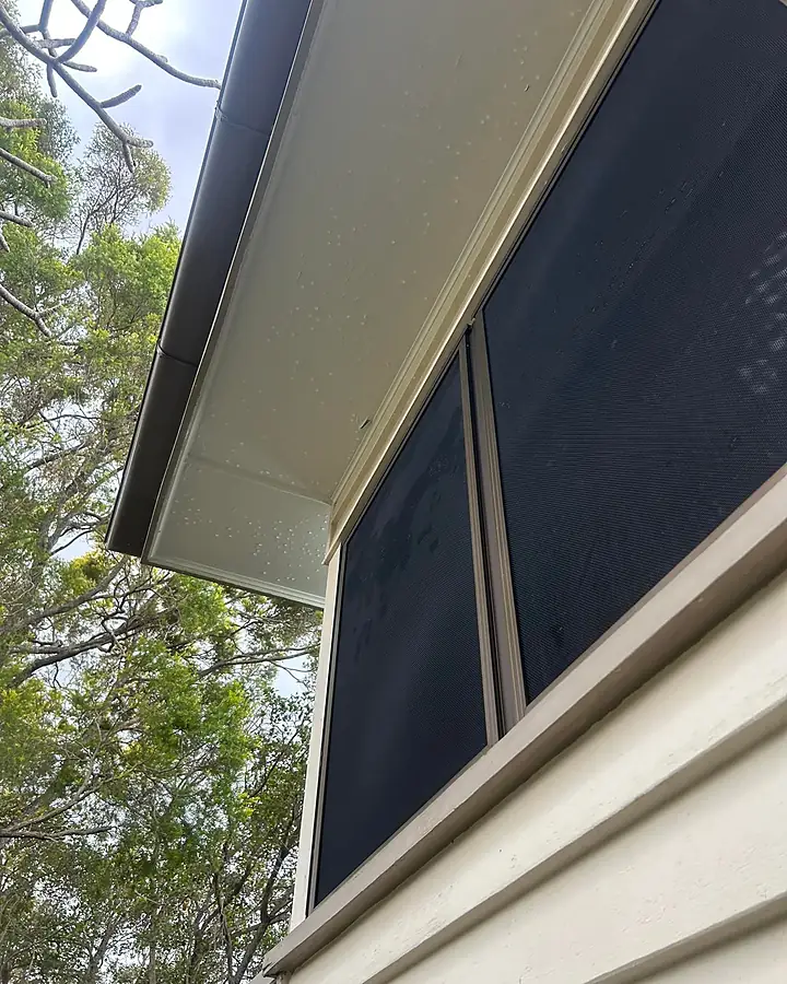 The same eave, soffit and sill noticeably cleaner after washing