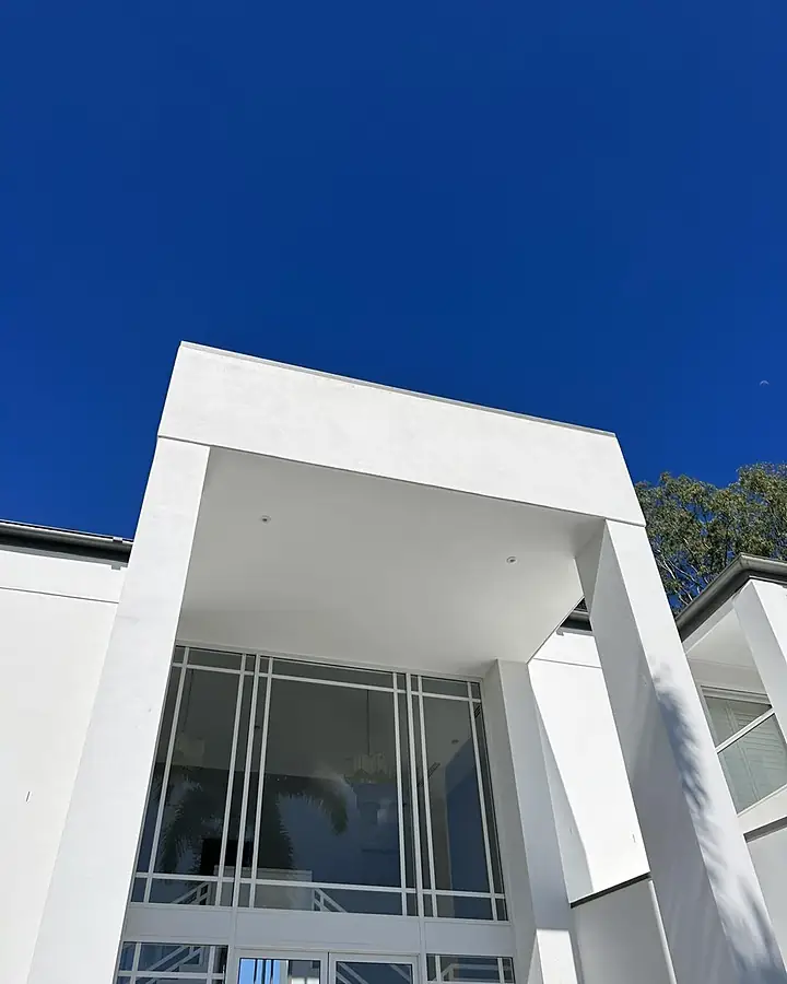 The same rendered portico bright white after a soft wash